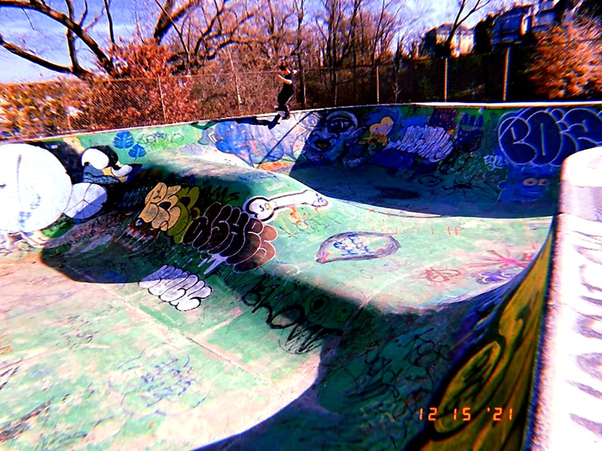 Graffiti skate park bowl with a skater
