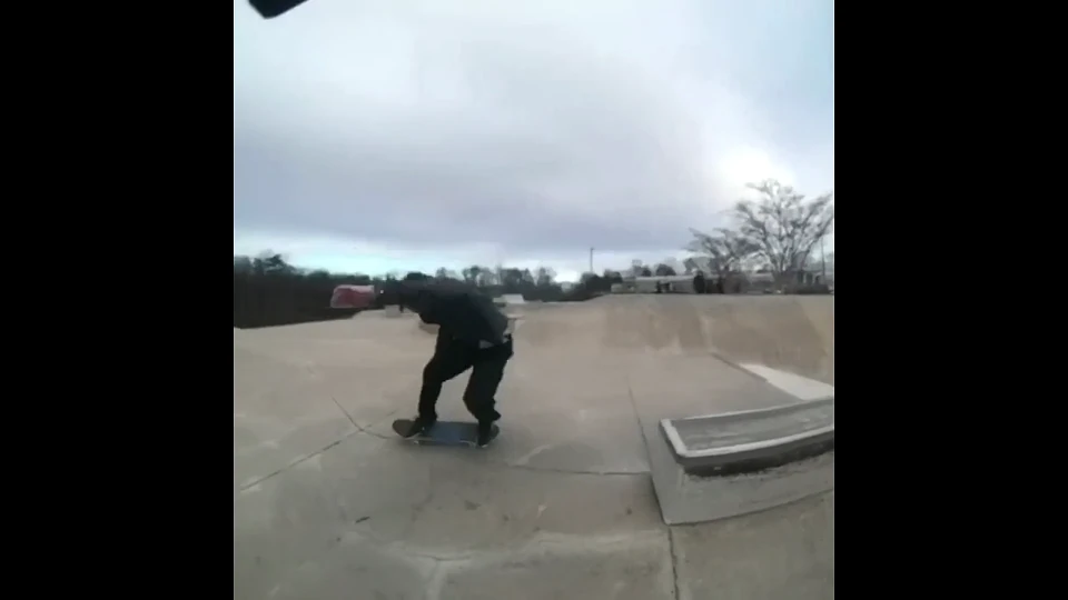 A frame from the recorded MikeSullyTools export: a skateboarder under an overcast sky, still visibly soft in fine detail.